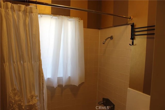 bathroom with shower / bath combo with shower curtain