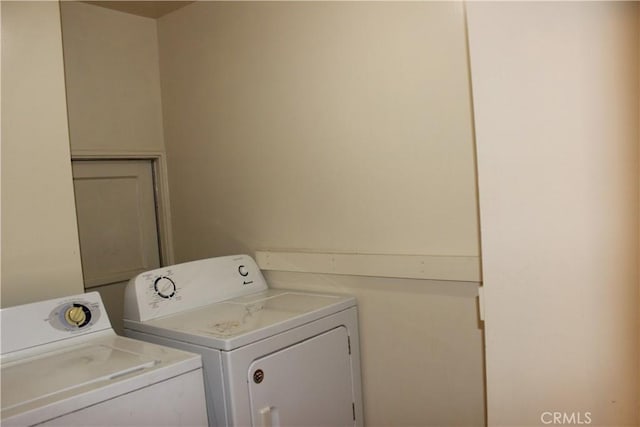 clothes washing area featuring independent washer and dryer