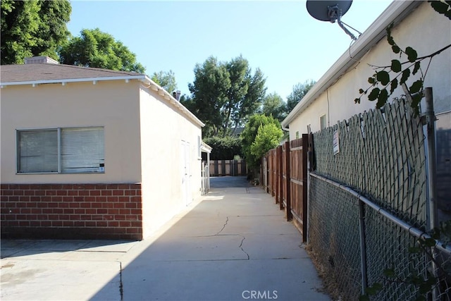 view of side of home with a patio area