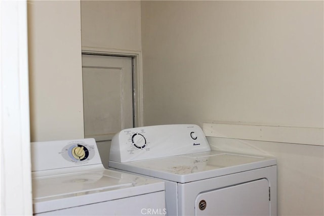 clothes washing area featuring independent washer and dryer