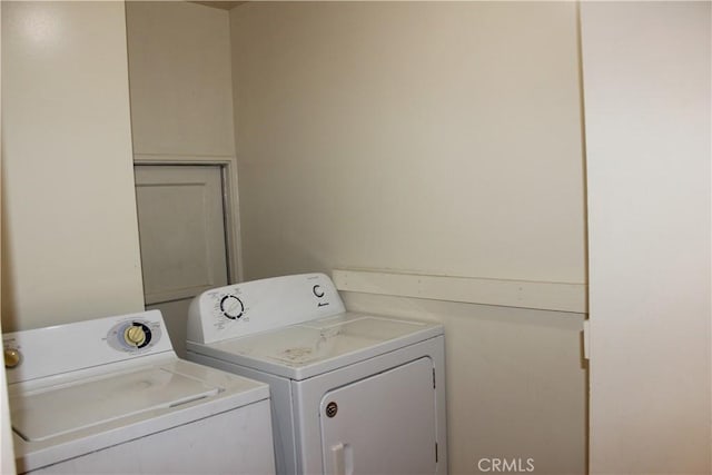 washroom with washing machine and clothes dryer