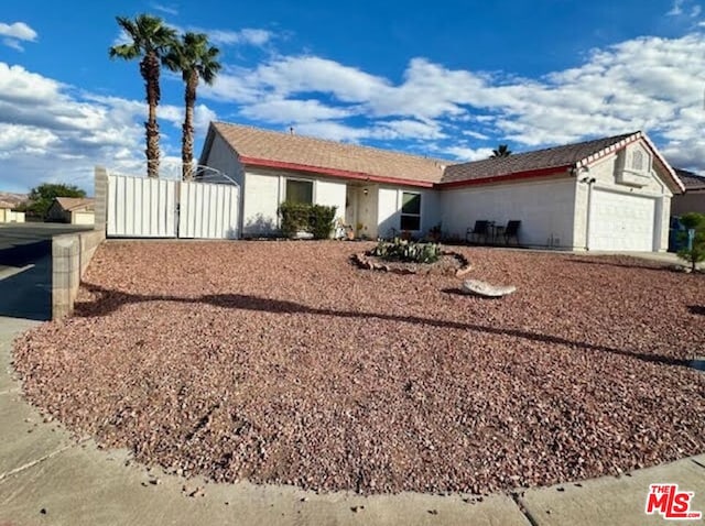 ranch-style home featuring a garage