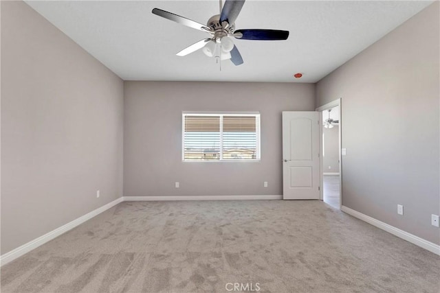 unfurnished room with ceiling fan and light carpet