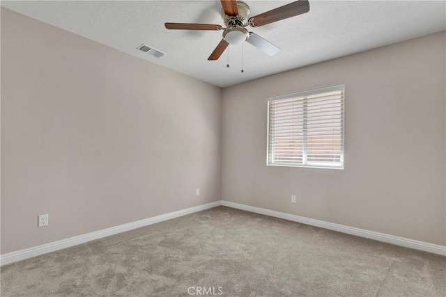 carpeted spare room with ceiling fan