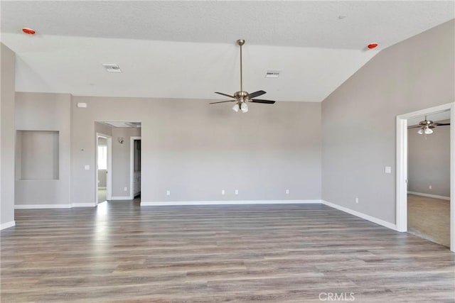 empty room featuring ceiling fan, light hardwood / wood-style flooring, and high vaulted ceiling