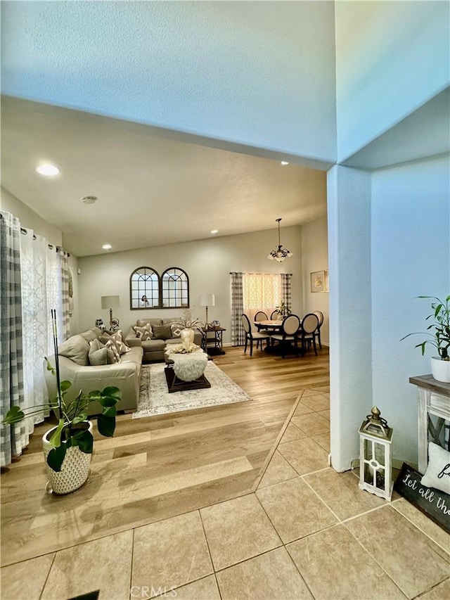 living room featuring tile patterned flooring, vaulted ceiling, and recessed lighting