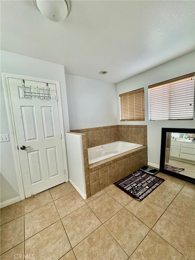 bathroom with tiled bath and tile patterned floors