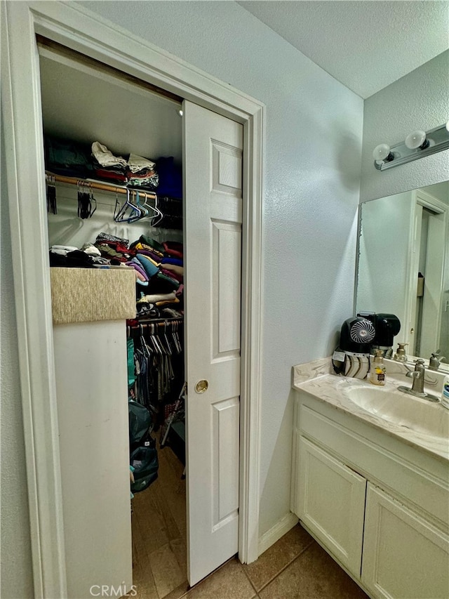 bathroom featuring tile patterned flooring and vanity