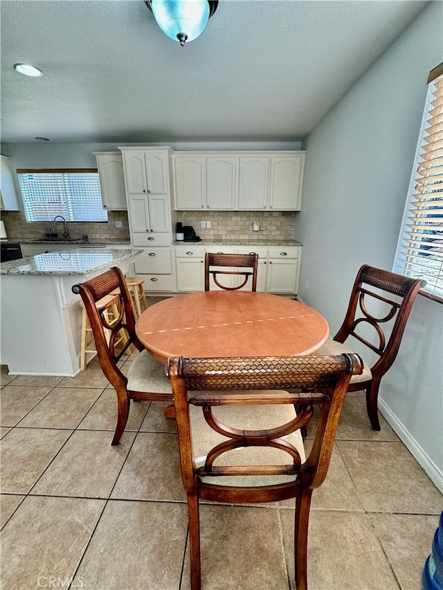 tiled dining room with sink