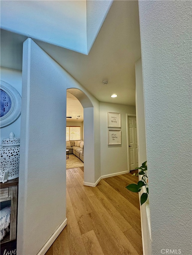 hallway with light hardwood / wood-style floors