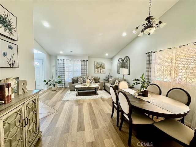 dining room featuring light hardwood / wood-style floors and vaulted ceiling