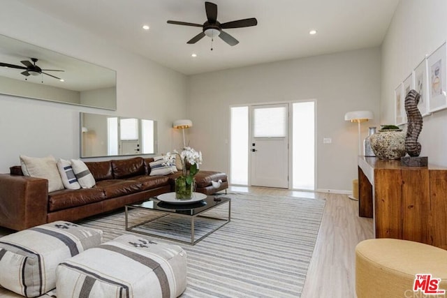 living room with ceiling fan and light hardwood / wood-style floors