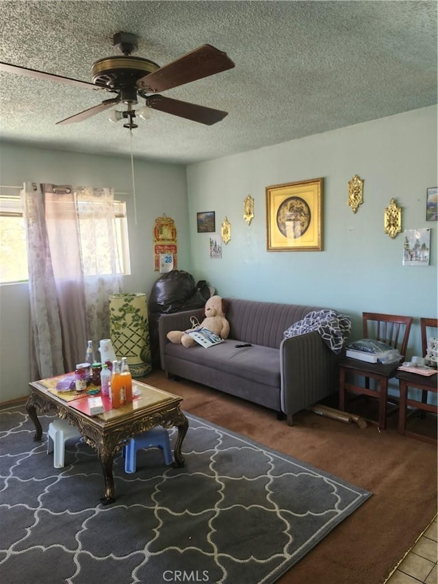 living room with carpet flooring, ceiling fan, and a textured ceiling