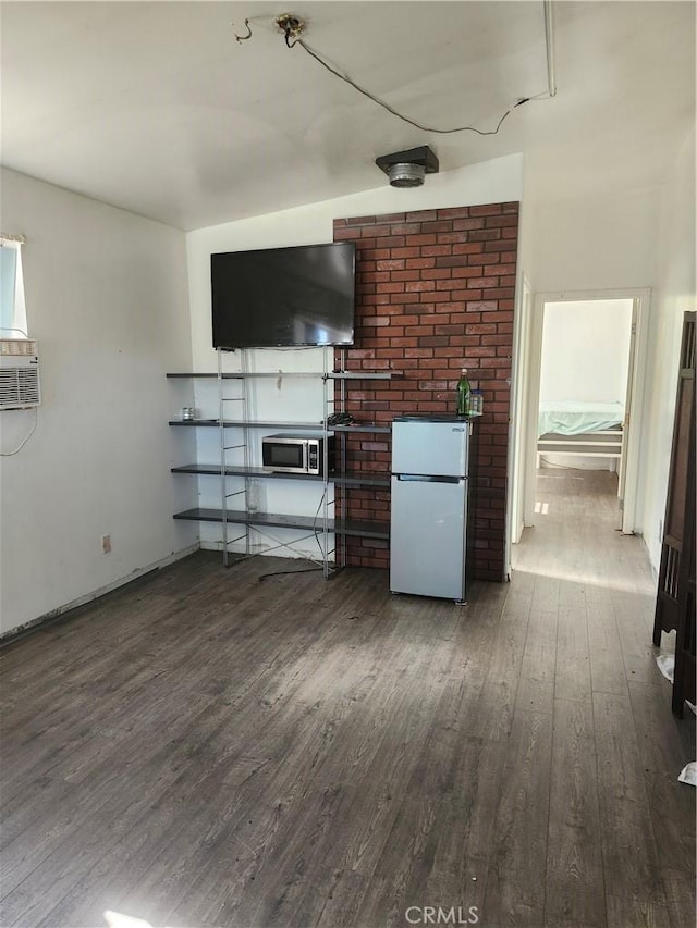 unfurnished living room with dark hardwood / wood-style flooring