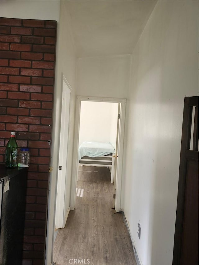 corridor with hardwood / wood-style flooring