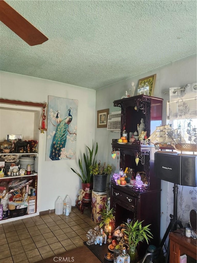 misc room featuring tile patterned floors and a textured ceiling