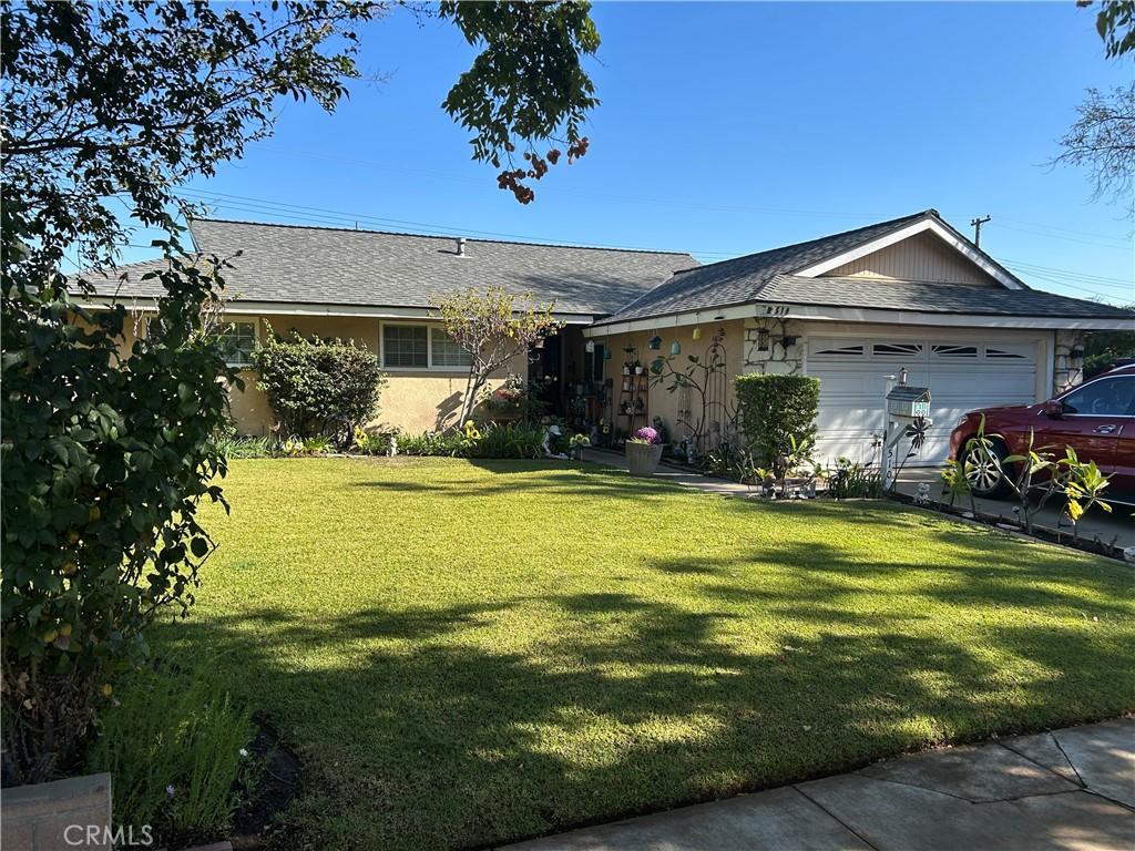 ranch-style home featuring a garage and a front yard