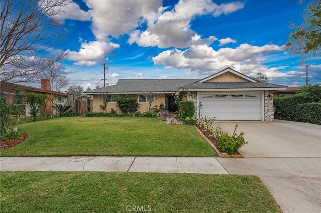 single story home featuring a front lawn and a garage