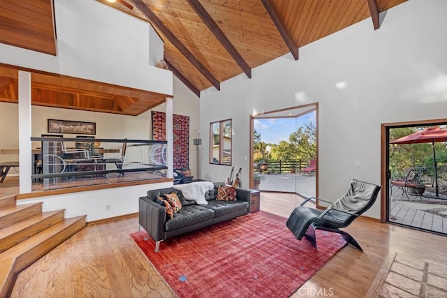 living room with light hardwood / wood-style flooring, beamed ceiling, high vaulted ceiling, and wood ceiling