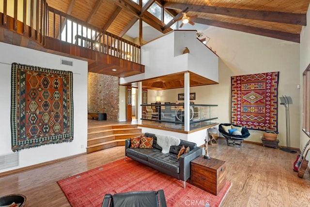 living room with high vaulted ceiling, hardwood / wood-style flooring, ceiling fan, wooden ceiling, and beam ceiling