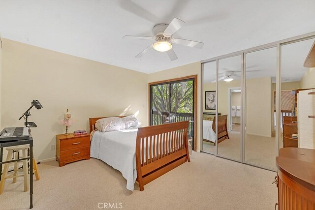 bedroom with ceiling fan and light carpet