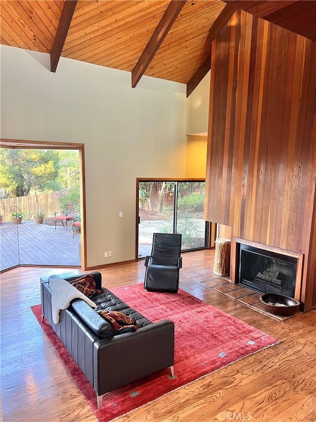 living room with high vaulted ceiling, beam ceiling, and wooden ceiling