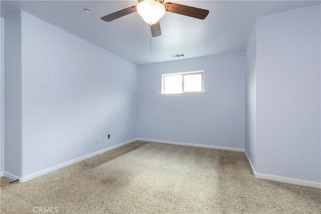 carpeted spare room with ceiling fan