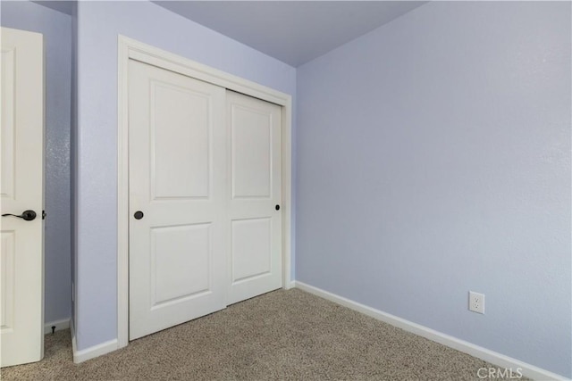 unfurnished bedroom with carpet and a closet