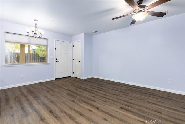 foyer entrance with dark wood-type flooring and ceiling fan with notable chandelier