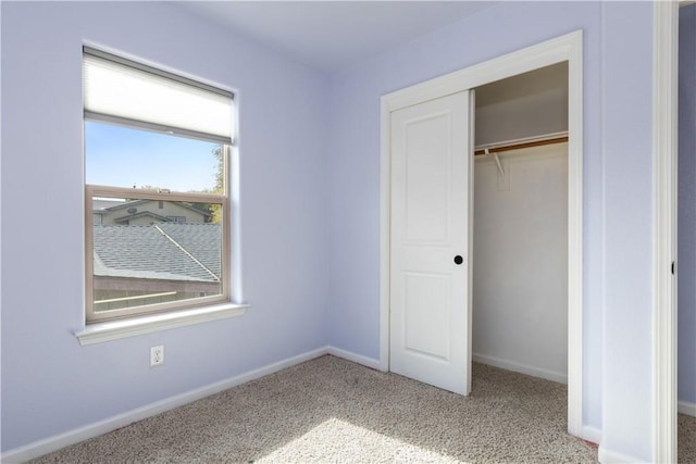 unfurnished bedroom featuring carpet and a closet