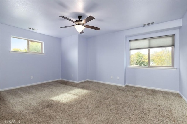 spare room with carpet and ceiling fan