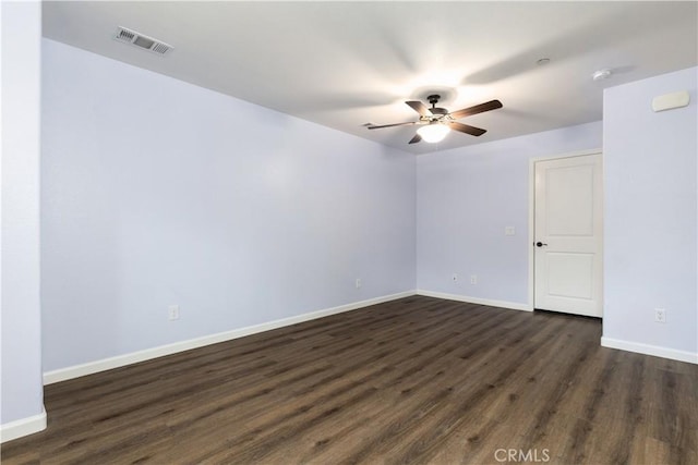 empty room with ceiling fan and dark hardwood / wood-style floors