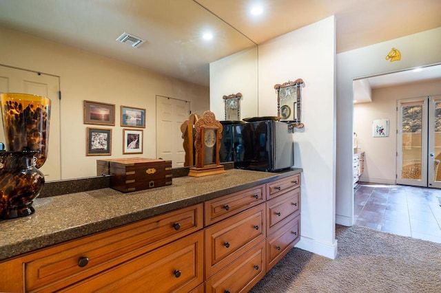 bathroom featuring tile patterned flooring and vanity