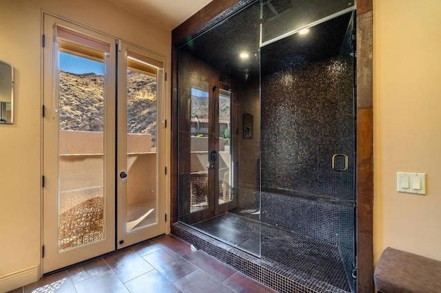 entryway featuring french doors and dark tile patterned flooring