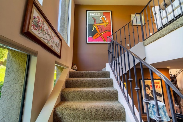 staircase with a towering ceiling