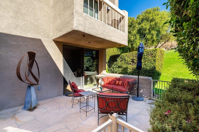 view of patio featuring an outdoor living space and a balcony