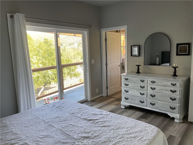 bedroom with hardwood / wood-style flooring and access to outside