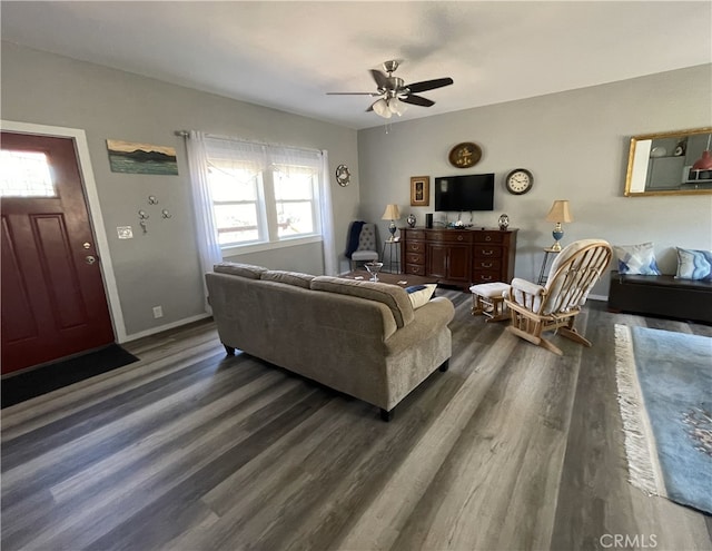 living room with dark hardwood / wood-style flooring and ceiling fan