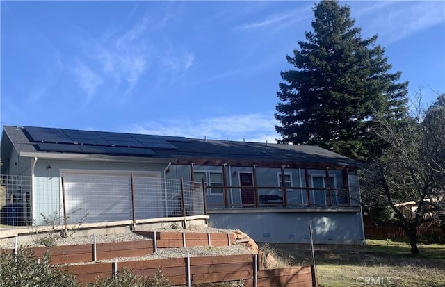 view of front of house featuring solar panels and a garage