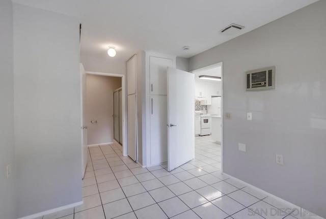 hall with light tile patterned floors