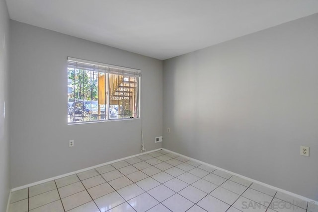 spare room featuring light tile patterned floors