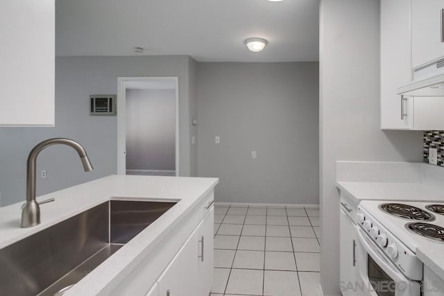 kitchen featuring white cabinetry, sink, and light tile patterned floors