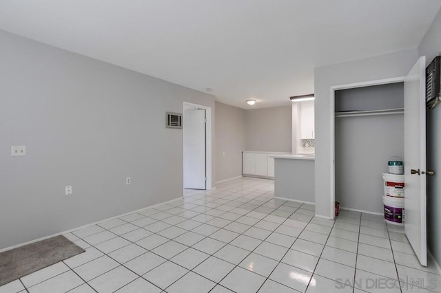 unfurnished bedroom featuring light tile patterned flooring and a closet