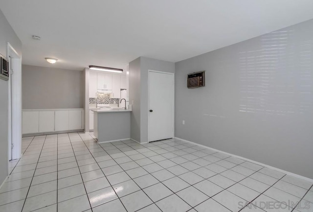 spare room with sink and light tile patterned floors