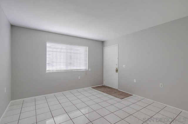 spare room featuring light tile patterned flooring