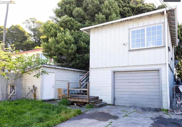 rear view of house with a garage