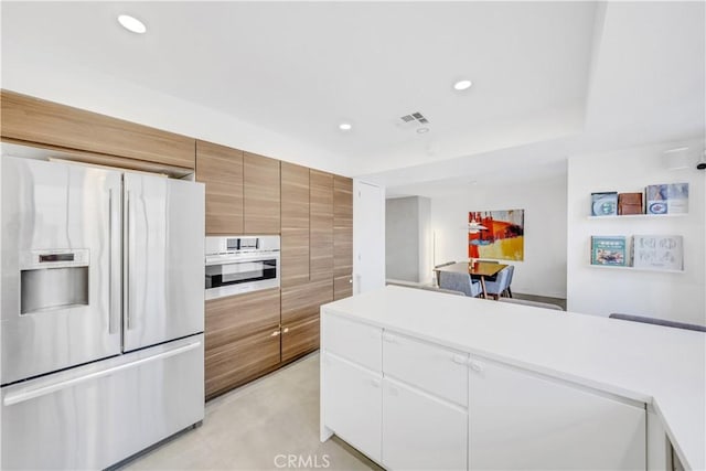 kitchen featuring white cabinets and appliances with stainless steel finishes