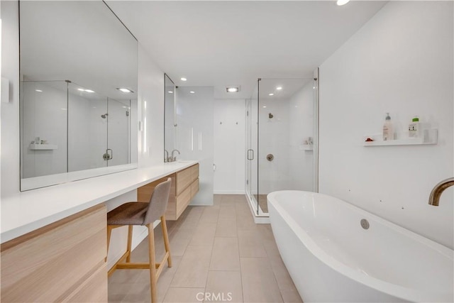 bathroom with tile patterned flooring, shower with separate bathtub, and vanity