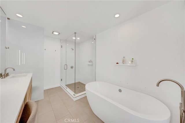 bathroom with vanity, tile patterned flooring, and plus walk in shower