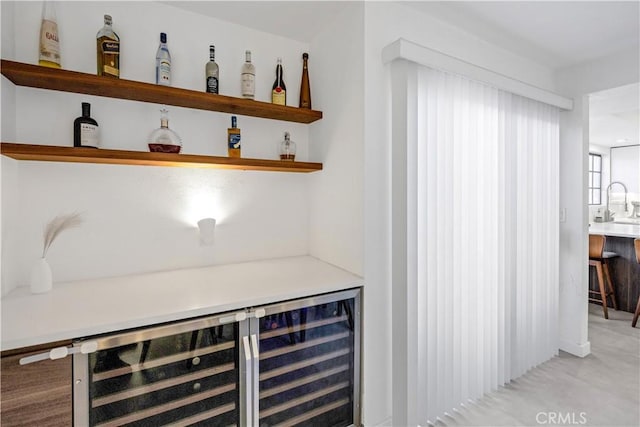 bar featuring wine cooler and sink